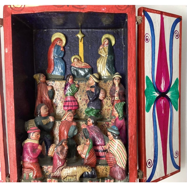 This handcrafted Peruvian folk art diorama features a vibrant nativity scene. These folk art pieces are popular Christmas...