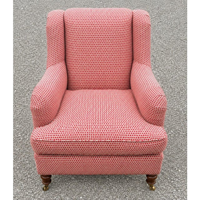 Beautifully crafted O’Henry House armchair featuring a classic English-inspired silhouette with gracefully rolled arms, a...