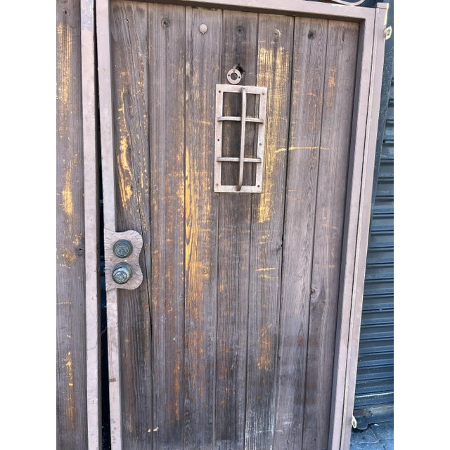 Introducing a pair of vintage wooden double entry gates featuring speakeasy detailing and exquisite Spanish-style accents....
