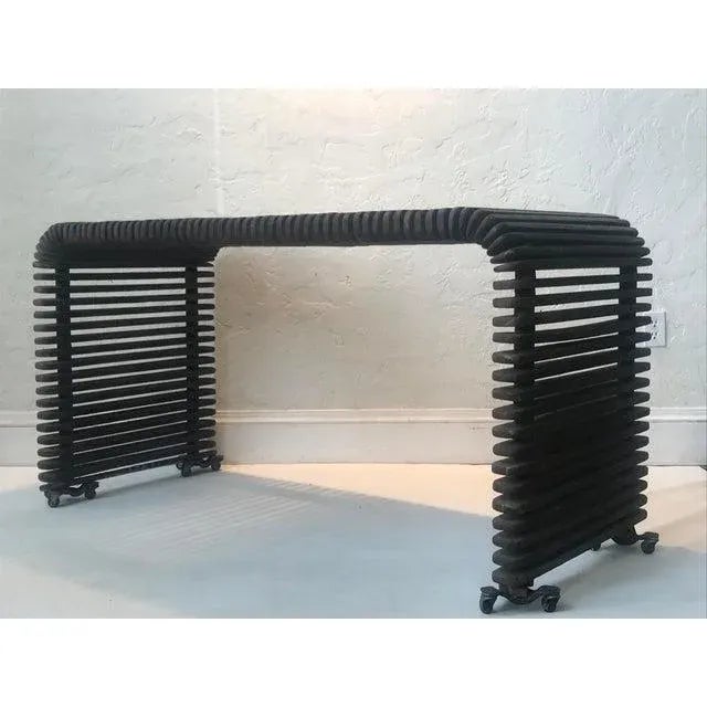 Dramatic and beautifully crafted, this slatted waterfall wood console makes a striking statement in any setting. The piece...