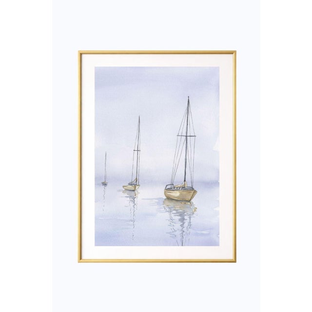 Sailboat wall art featuring three minimalist boats resting on calm water with soft reflections and muted coastal tones....