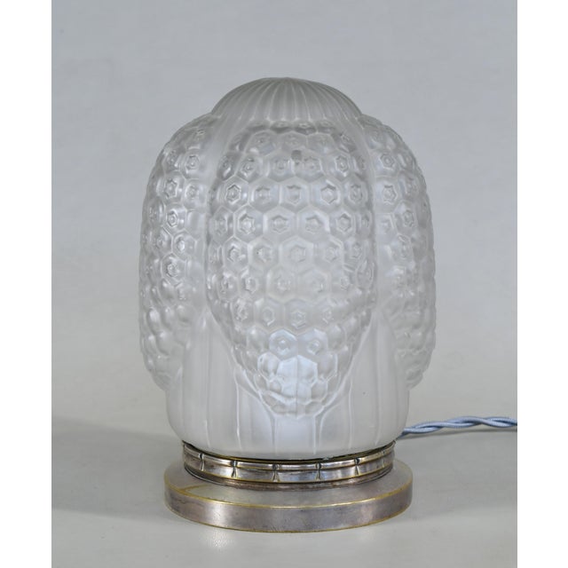 Simonet frères & Dieupart A beautiful French 1925-1930 art deco lamp in silver plated solid brass or bronze holding a...