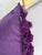 Pillow in solid deep purple color. Has purple fabric flowers on one side. Invisible zipper with feather pillow insert.