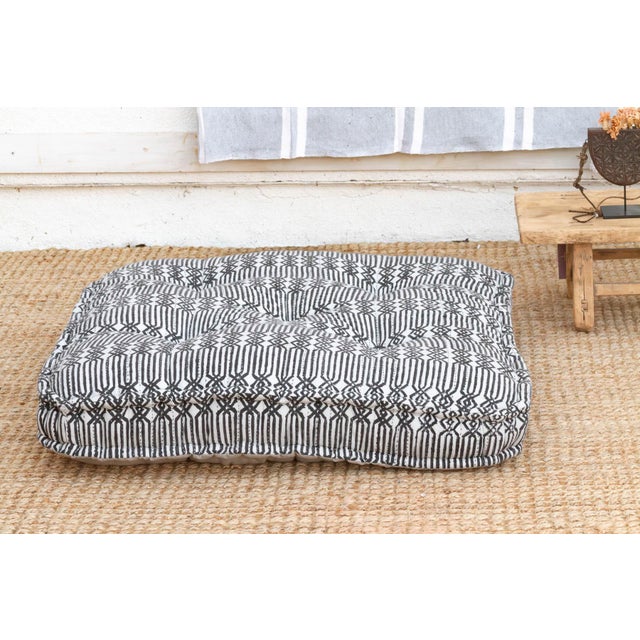 A fusion of traditional craft and modern graphic design, this oversized floor cushion features a striking Black & White...