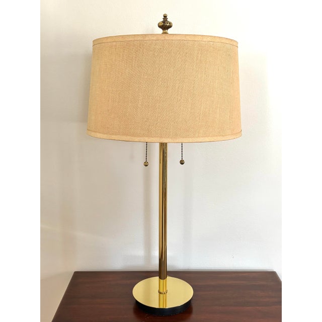 Attractive midcentury modern brass lamp, with clean and straight lines. Two light pulls. Includes a contemporary linen...