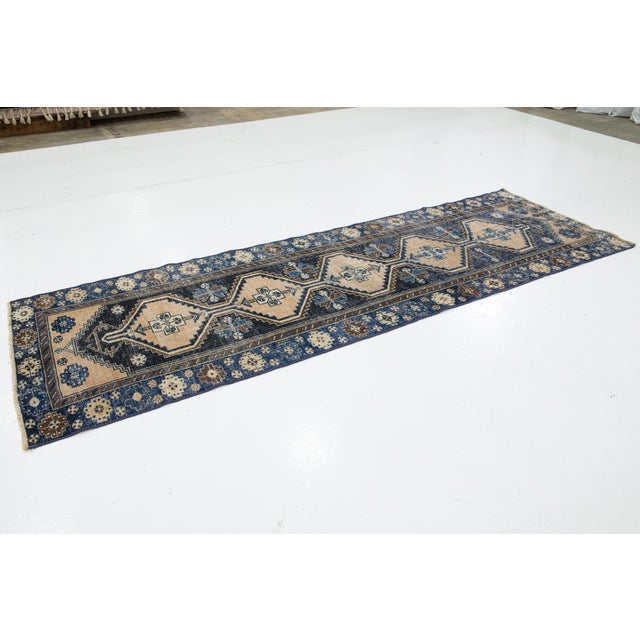A beautiful Vintage Persian Handmade Wool Rug with a blue field and beige accents in Tribal design. This rug measures...