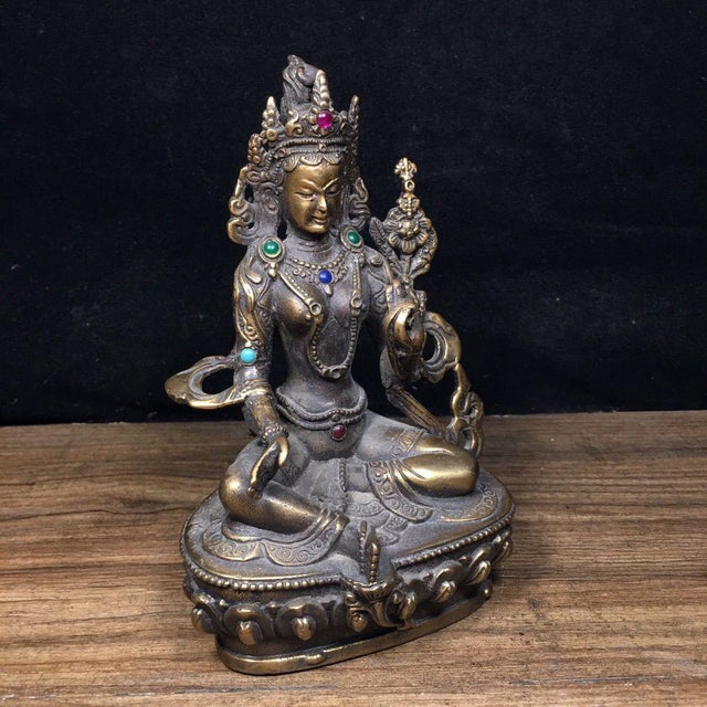 This exquisite vintage sculpture depicts Green Tara, the Buddhist goddess of compassion and action, crafted from bronze...
