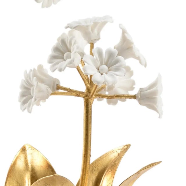 Hand formed porcelain auricula flowers on gold leaf iron stem in a crystal vase.