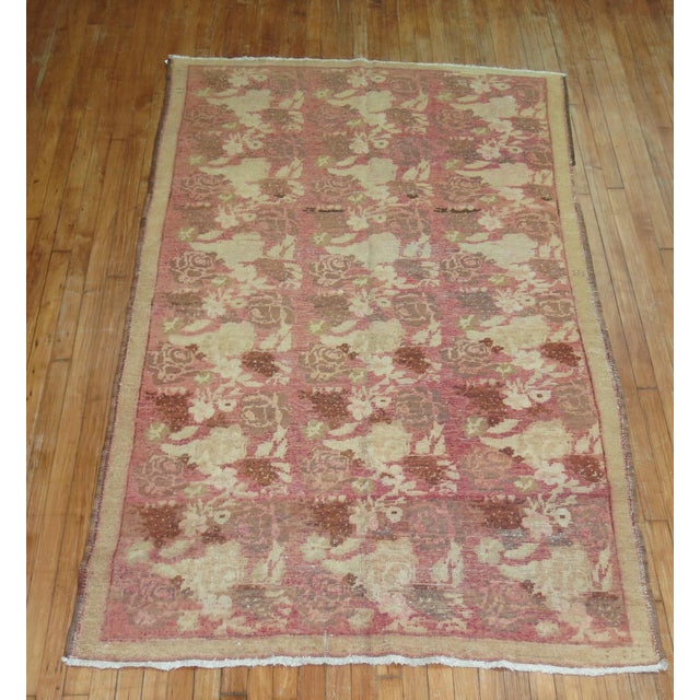 A mid 20th century Russian Karabagh Accent Size rug with brown and beige accents on a pink field Measures: 4'6'' x 7'8''.