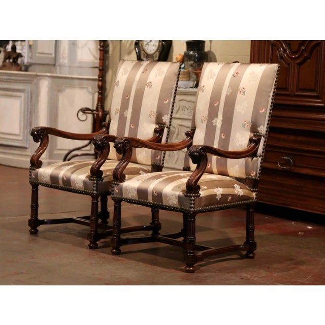 Crafted in Southern France circa 1870, this elegant pair of antique Louis XIII armchairs combines bold sculptural carving...