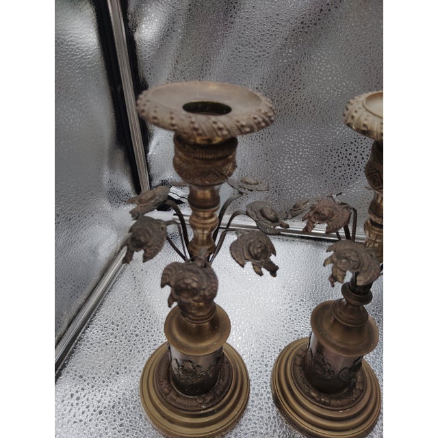 The candleholders appear to be antique, from an Art Deco period. I tried to detach a clean on of the candleholders but not...