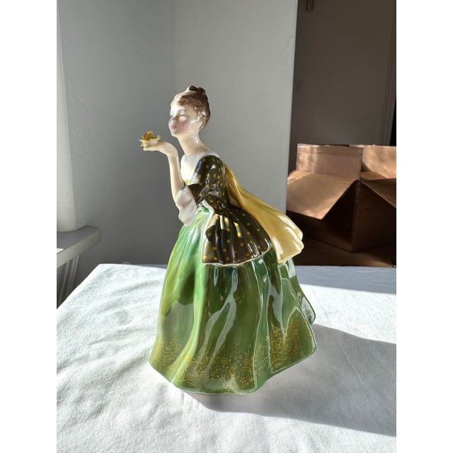 “Fleur” (H.N. 2368) is a distinguished Royal Doulton porcelain figurine introduced in 1961. Modeled with exquisite detail...