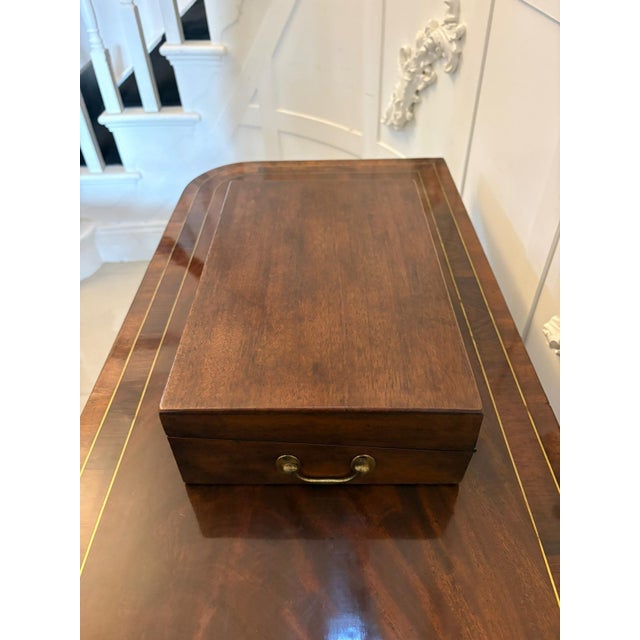 A charming antique Georgian mahogany writing slope box of rectangular form with brass carrying handles and original...