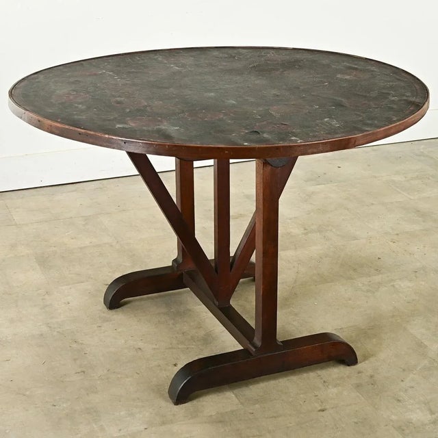 Dimensions: 28 ⅞” H x 44 ¼” W x 43 ½” D This French walnut 19th century wine tasting table, properly known as a vendange,...