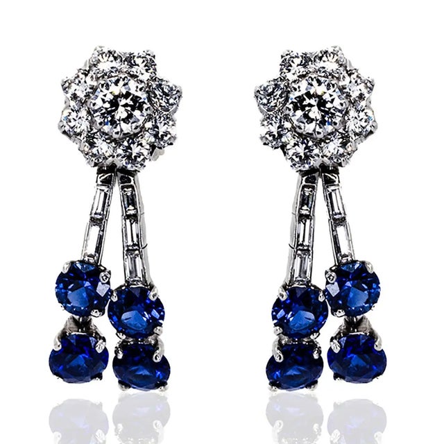 Elegant platinum earrings featuring 8 unheaded round sapphires, each weighing approximately 3.90 carats, accompanied by 18...