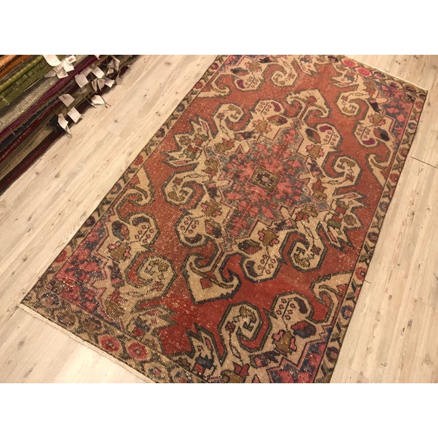 This is a vintage Turkish Oushak rug from the 1960s. The piece was hand-knotted.