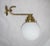 A few large wall lamps in Bauhaus style. Brass and opal glass. Diameter opal glass ball is 16 cm Up to 250V (Europe/UK...