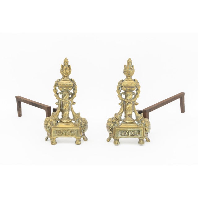 French Empire Style Brass Chenets, early 20th century, each column form with flame finial. 13" H x 18" W x 6.75" D....