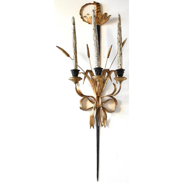A vintage, mid-century Florentine Italian tole metal wall sconce, 3-arm candle holder, with a gold gilt and black metal...