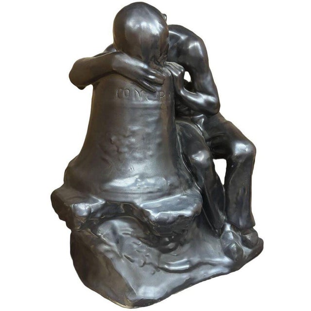 Offered is a striking Art Deco period terracotta sculpture depicting a contemplative male figure seated beside and leaning...