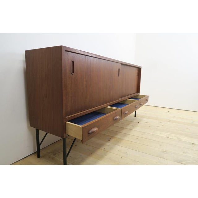 Teak sideboard with sliding doors and drawers, 1960s