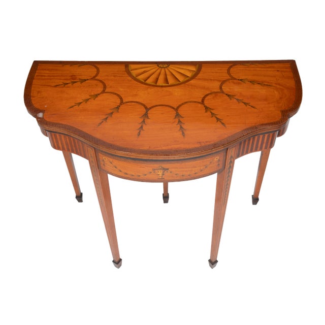An elegant late 19th-century English Adams-style satinwood games table, attributed to the renowned London cabinetmakers...