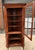 Henkel Harris corner cabinet in classic wild cherry, offering refined traditional styling and practical display storage. A...