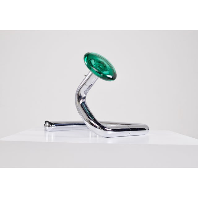 Mobile lamp in chromed tubular steel, topped with a translucent emerald murrine shade, reminiscent of the iconic "snake...