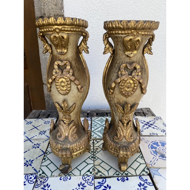 matched pair of ornate carved wooden pedestal stands ,finished in gold gilded leaf The flowing curves, scrolling foliage,...