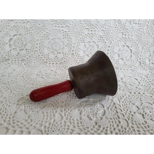 An antique school bell measuring approximately 8” h x 5” diameter. A fun conversation piece for a modern farmhouse. This...