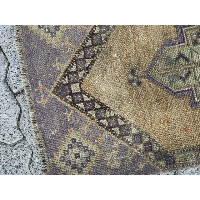 This is a vintage Turkish Oushak rug from the 1960s. The piece was hand-knotted.