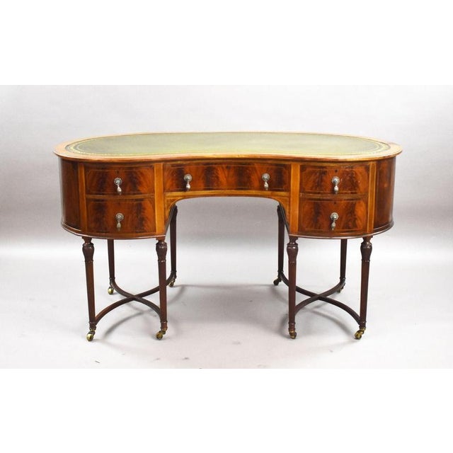 Edwardian Flame Mahogany Kidney-Shaped Writing Desk Item Code: LC1386 A highly attractive Edwardian flame mahogany kidney-...