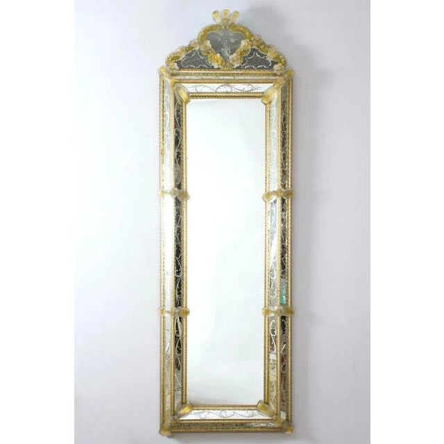 This beautiful Venetian mirror features etched floral motifs adorning the mirrored frame. Along the edges of the frame are...