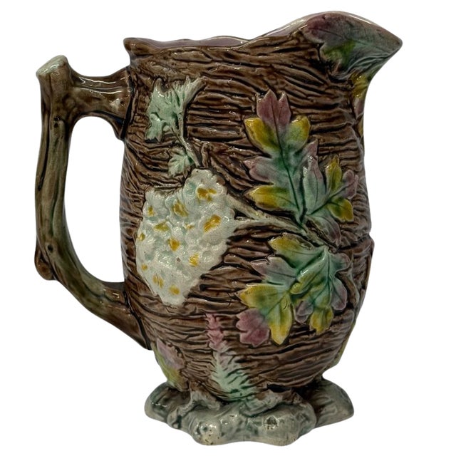 A richly modeled antique English majolica pitcher that brings the Victorian fascination with the natural world into...
