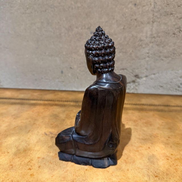 For your consideration, a hand-carved wooden Buddha statue, likely originating from Indonesia or Southeast Asia, depicted...