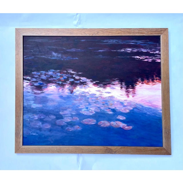 Mid century take on impressionism. This vintage oil painting shows a lake with lily pads at dusk with hills behind. The...