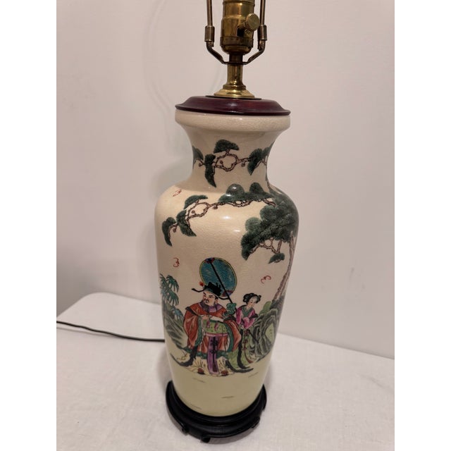 A mid-20th century Chinese Famille Rose porcelain vase lamp decorated with finely painted figures in traditional robes...