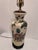 A mid-20th century Chinese Famille Rose porcelain vase lamp decorated with finely painted figures in traditional robes...