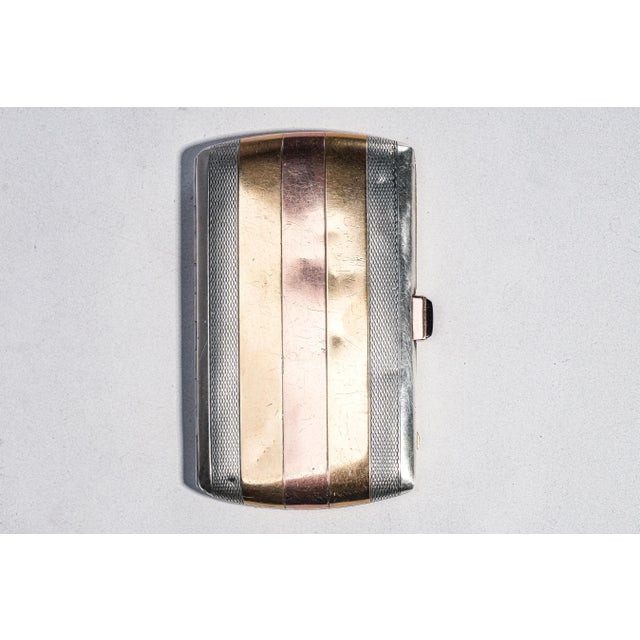 An exceptional example of French luxury craftsmanship, this antique sterling silver cigarette case is a striking fusion of...
