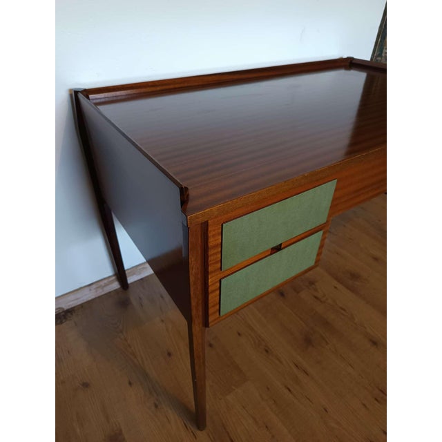 Elegant Italian design desk from the 1960s. The piece of furniture is in very good condition except for a small stain on...