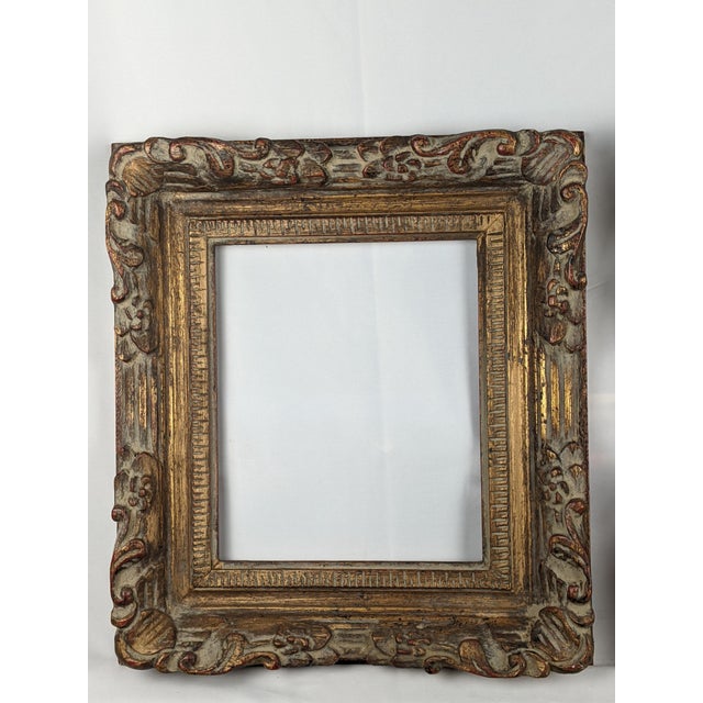 An impressive matching pair of grand European-style giltwood picture frames, richly ornamented with sculptural acanthus...