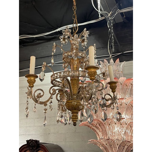 Early 20th century petite Italian giltwood and crystal 4-light chandelier. Circa 1920. The chandelier has been...