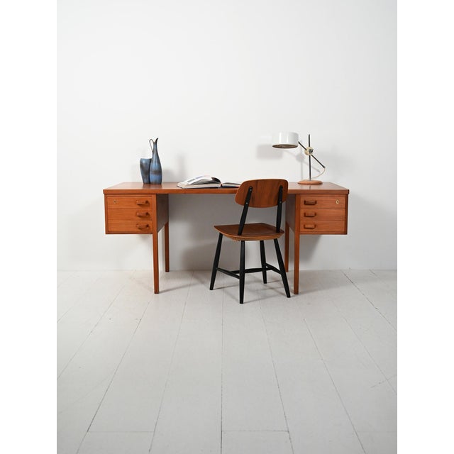 Nanna & Jørgen Ditzel, model "135." Danish teak desk from the 1950s/1960s, with a double floating drawer unit, locks, and...