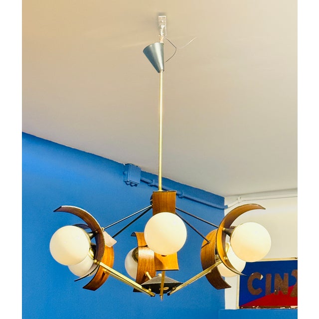A stunning mid-twentieth-century pendant lamp, a true gem of Italian lighting design. Featuring a dynamic and striking...