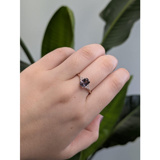 A rare 1.43-carat cushion-cut grey spinel from Madagascar takes center stage in this refined 14K rose gold ring. Its...