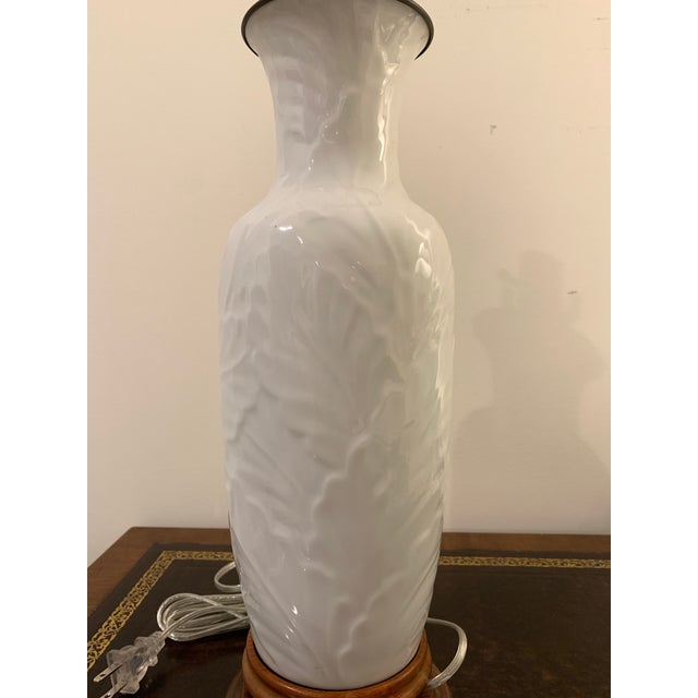 An elegant white chinoiserie porcelain vintage lamp with raised foliage motif. Approximately 18 1/2” high from base to top...