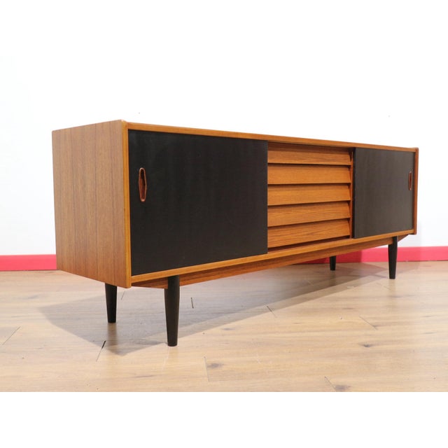This Mid Century Modern Vintage Teak Credenza Sideboard by Nils Jonsson for P.S Hegg is a very rare piece of furniture...