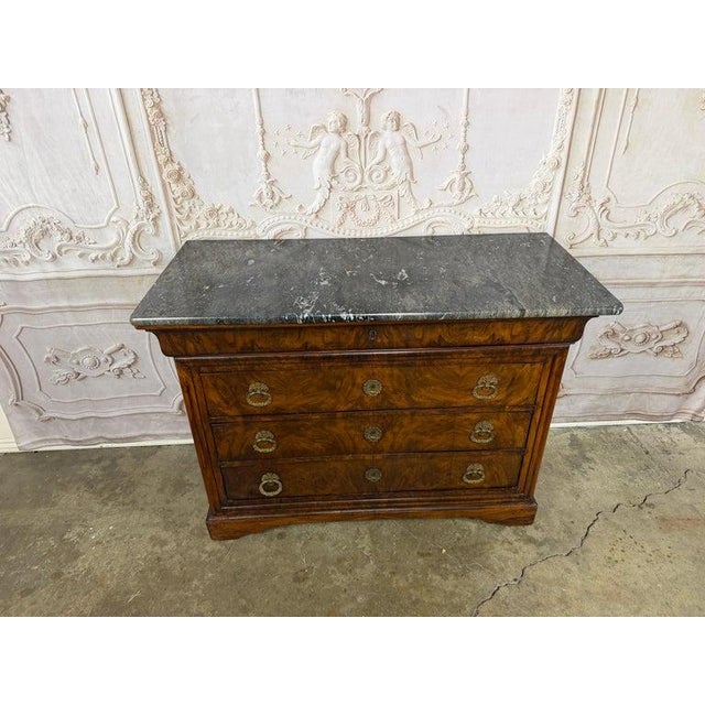 19th Century French Louis Philippe burl walnut commode, a quintessential example of 19th-century French craftsmanship and...