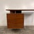 This is a mid century walnut writing desk by RWAY Furniture. This piece features a “floating” set of three drawers with a...