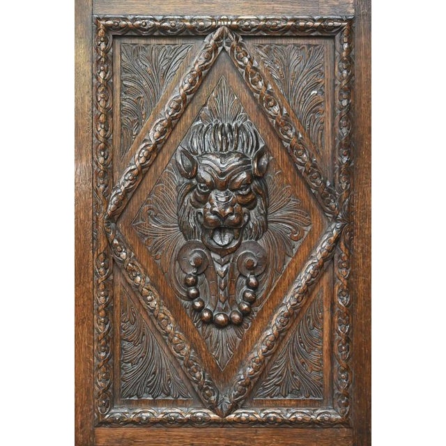 Massive oak cabinet carved in Renaissance style. Rich carvings run along the entire front and are dominated by two lion...